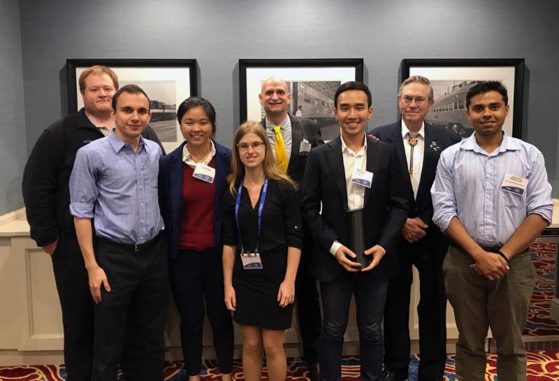 Adam Zachar, Laura Gao and Jaimie Carlson from Team Proto Fluidics, Hyung Jin Yoo from Team H2, and Hasan Latif from Team Bengal Tigers standing with Mike Snyder of Made In Space, John Quinn from EXOS Aerospace and Edward Kiker from Kepler Space Institute.