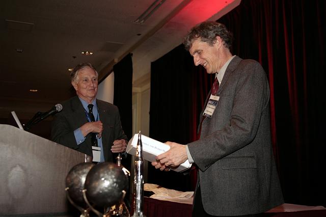 Mars Exploration Rover Principle Investigator Steven Squyres receiving a biography of Wernher von Braun from NSS Governor Frederick I. Ordway III at the International Space Development Conference  