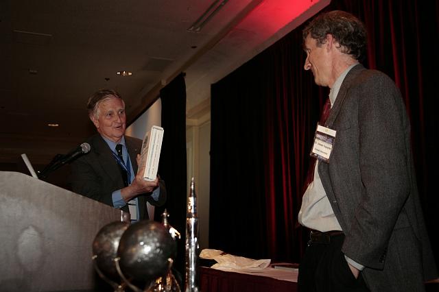 NSS Governor Frederick I. Ordway III presenting Steven Squyres with a biography of Wernher von Braun at the International Space Development Conference