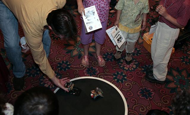 Kids play with robots at the Robotics Group exhibit at the International Space Development Conference