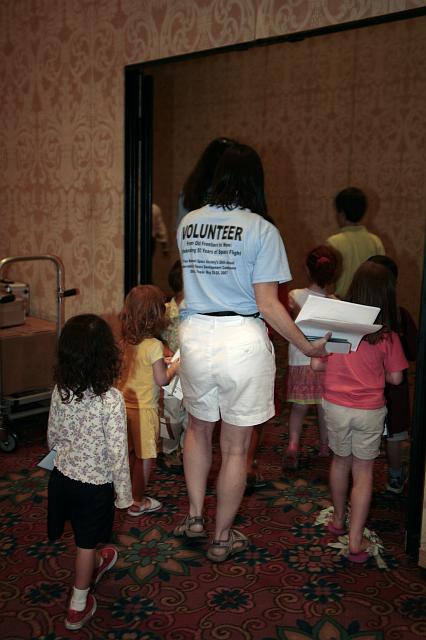 NSS volunteers give a tour of the exhibits to the children of attendees at the International Space Development Conference