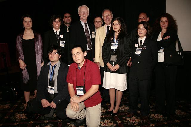 Apollo astronaut Schweickart and Ben Bova, author and member of the NSS Board of Governors, pose with a student group at the International Space Development Conference 