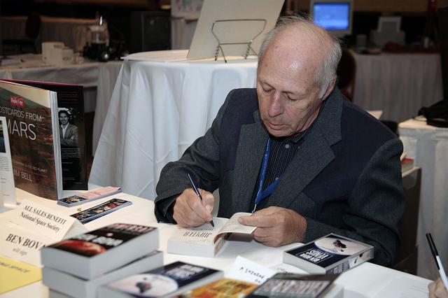 Author Ben Bova signs copies of his many books at the Authors Table at the International Space Development Conference  