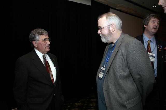 Space artist Walter Myers (R) speaks with former Apollo Astronaut and U.S. Senator Harrision 'Jack' Schmitt (L) following his presentation at the International Space Development Conference  