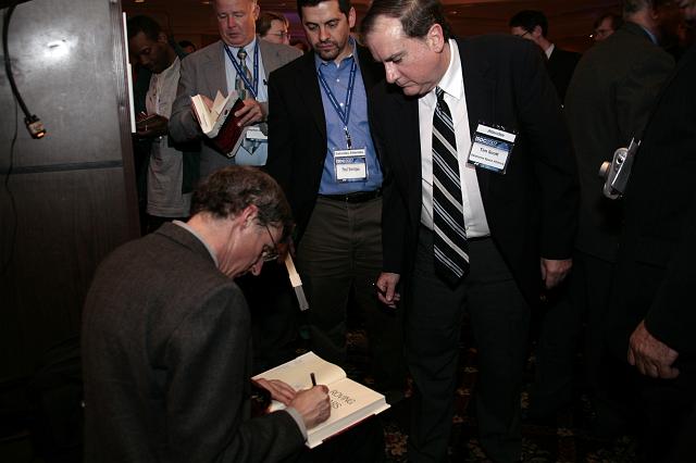 Steven Squyres signs copies of his book Roving Mars at the International Space Development Conference
